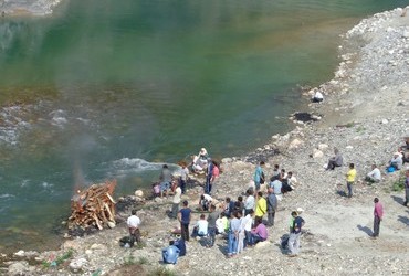 Bonfire to burn the dead - Remganga river, Thal, Uttarakhand, India