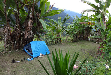 Camino precolumbino El Choro, Bella Vista, tent pitched on a football field, drinking Paceña beer - Bolivia